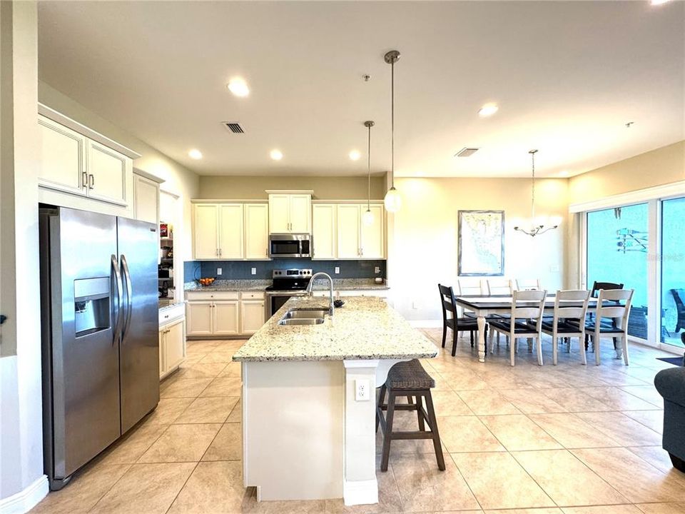 Abundantly sized chef kitchen with crown molding on the upper cabinets