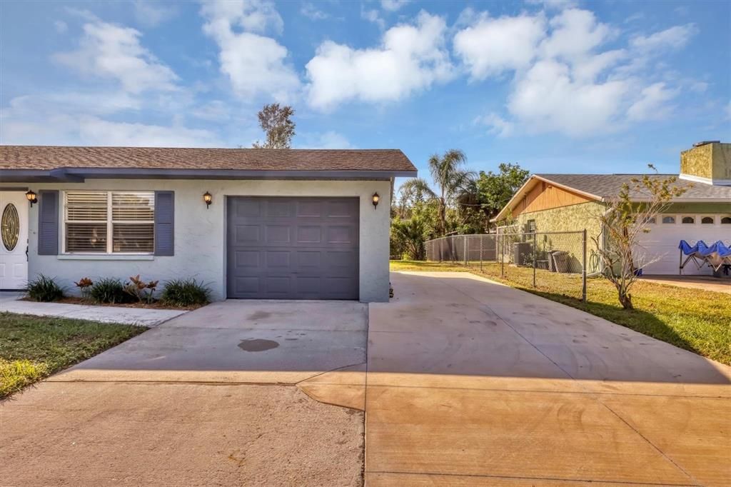 Over-sized garage with parking pad on the side