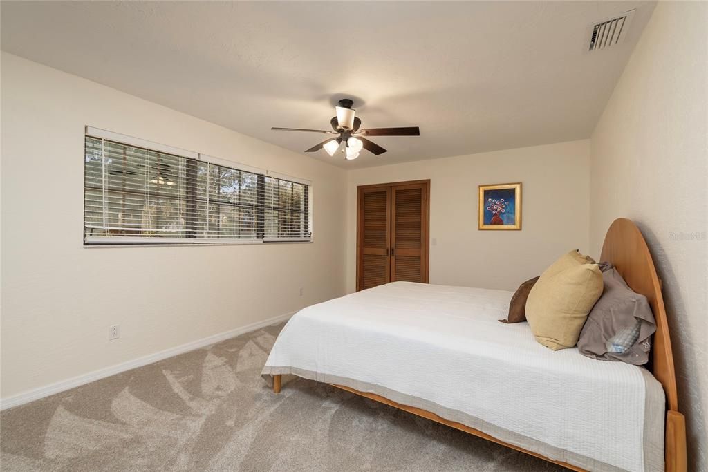 Guest bedroom with wooded views