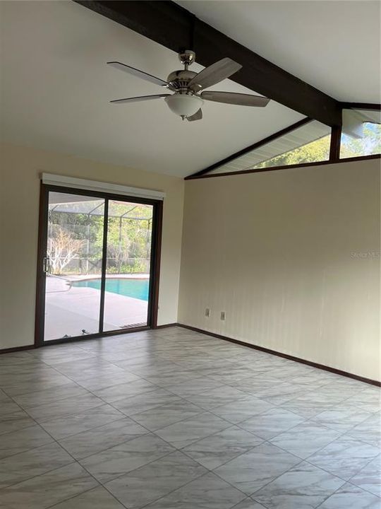 The primary bedroom also has sliding doors to the porch and nice view of pool.