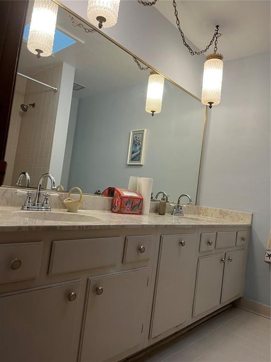 Double sink vanity nearby the secondary bedrooms.