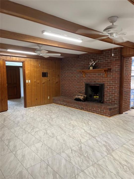 Beautiful brick wood-burning fireplace in large family room. (21'3" x16')