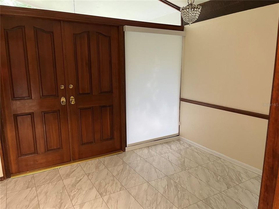 Inside the double-door foyer, 10'x9' with vaulted ceiling.