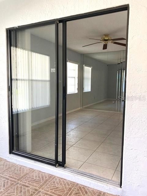 Sliding glass doors give access to the Florida room from the primary bedrdoom.