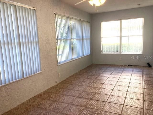 Florida room, with beautiful accent tile and large windows, is under heat/AC making this a comfortable retreat.