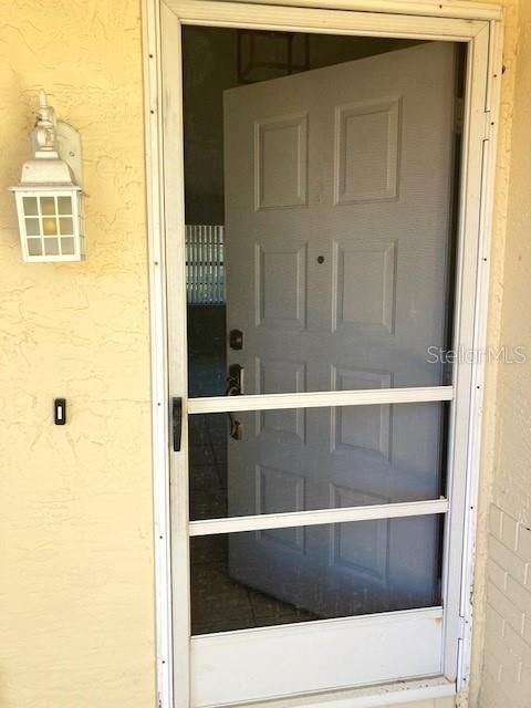 Front entryway includes a screen door, allowing a breeze through the house during the cooler months.