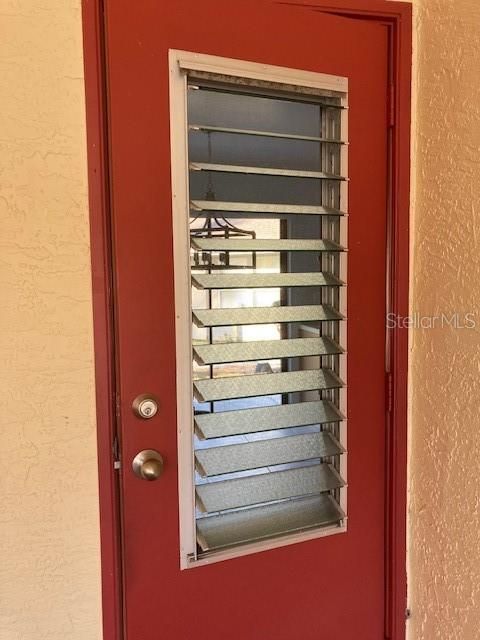 The jalousie windows on the carport door allow a cool breeze through the kitchen.