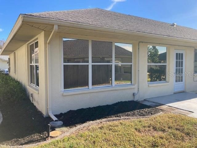 Back of the house, tinted windows along the Florida room.