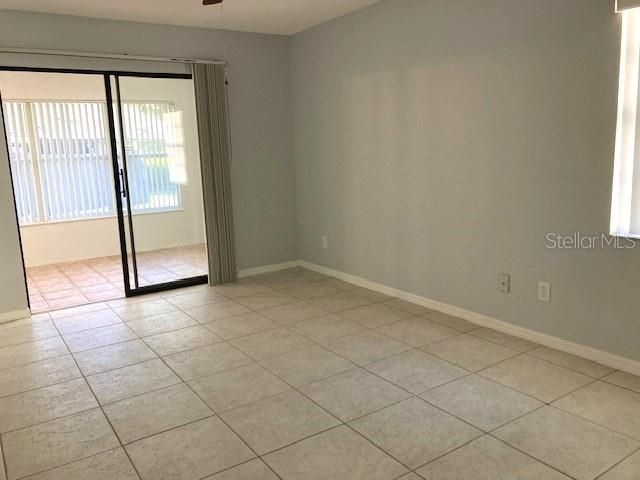 Primary bedroom, tiled floors.