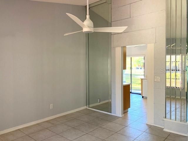 Entryway leads into a lovely dining area, with stylish ceiling fan and vaulted ceilings.