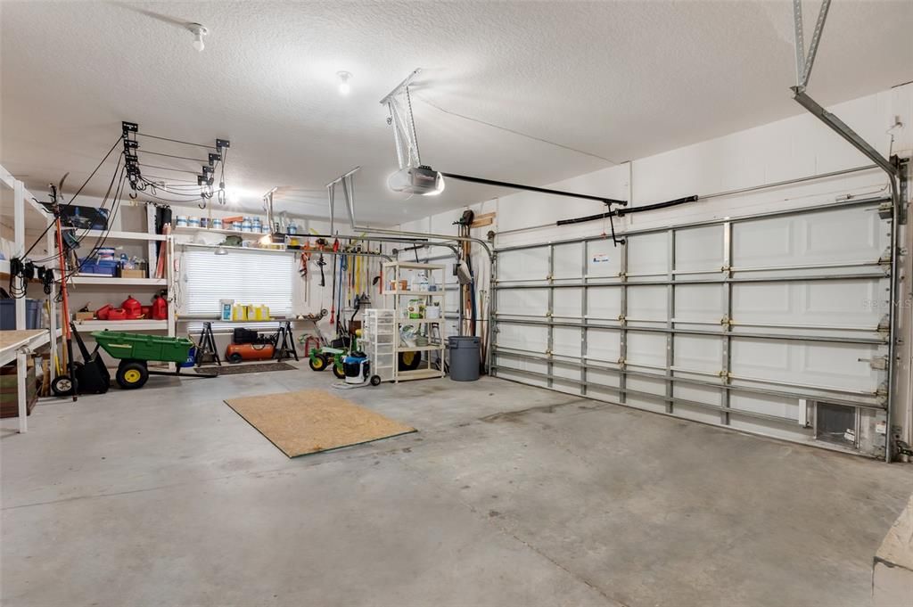 3-Car Garage features workshop area and built-in shelving.