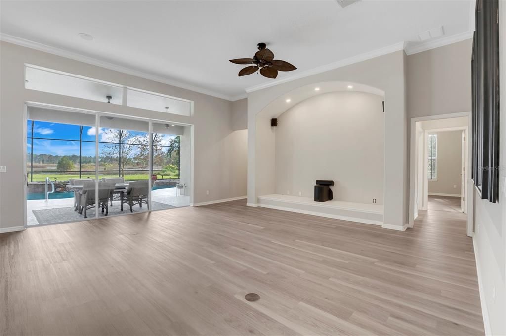 Spacious and inviting, this large family room is ideal for hosting grand gatherings or enjoying tranquil moments at home. The triple sliding doors fully open, seamlessly blending indoor and outdoor living for an exceptional experience.