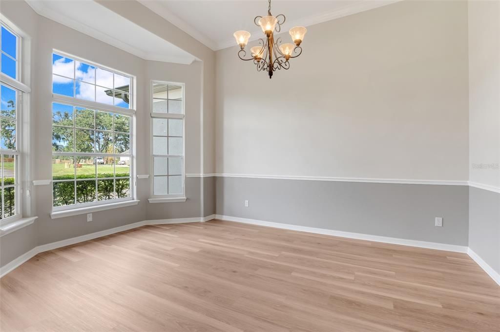 Dining Room features luxury vinyl flooring and boasts delightful views of this meticulously maintained property.