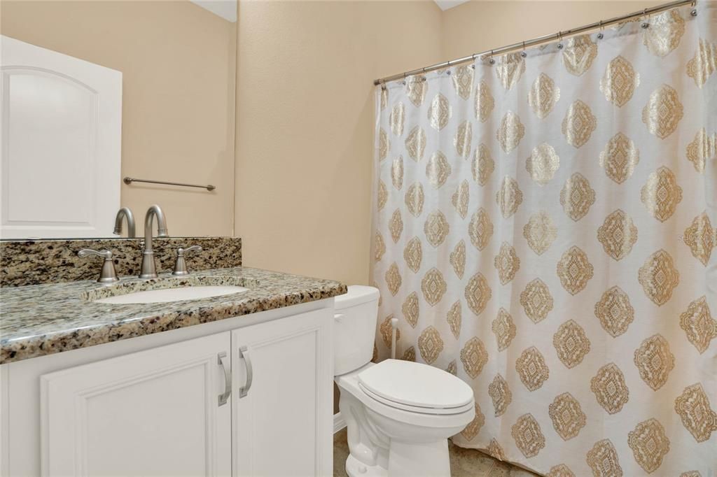 THE MAIN BATHROOM OFFERS OVERSIZED GRANITE TOP VANITY AND A LINEN CLOSET FOR EXTRA STORAGE SPACE IS LOCATED RIGHT OUTSIDE FOR CONVENIENCE