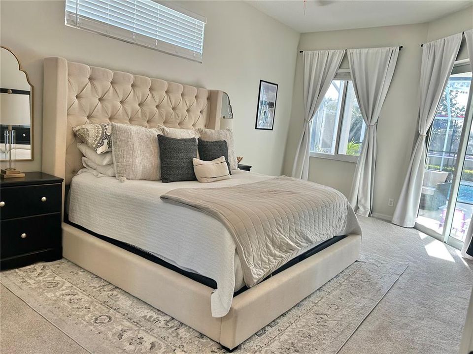 Primary Bedroom with pool views and sliding door