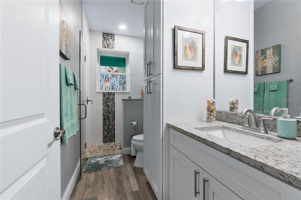 Designer Bathroom with Tastefully Tiled Shower