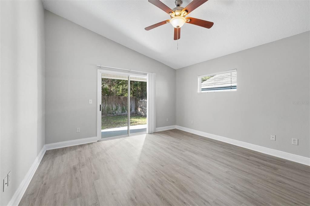 Primary Bedroom - Vaulted Ceilings + Backyard Access