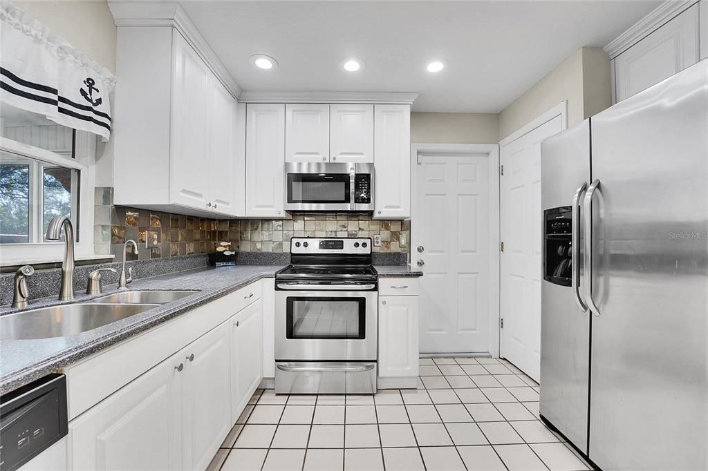 Updated Kitchen with Corian Countertops and Stainless Steel Appliances