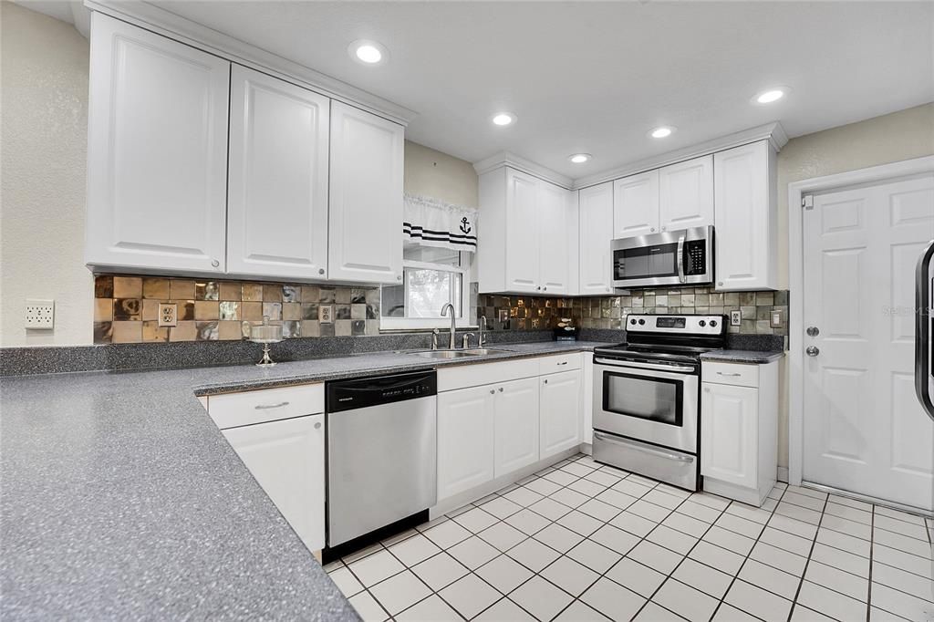 Updated Kitchen with Corian Countertops and Stainless Steel Appliances