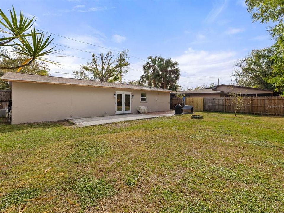 GINORMOUS fully fenced backyard. Trim on the back of the home is being freshly painted.