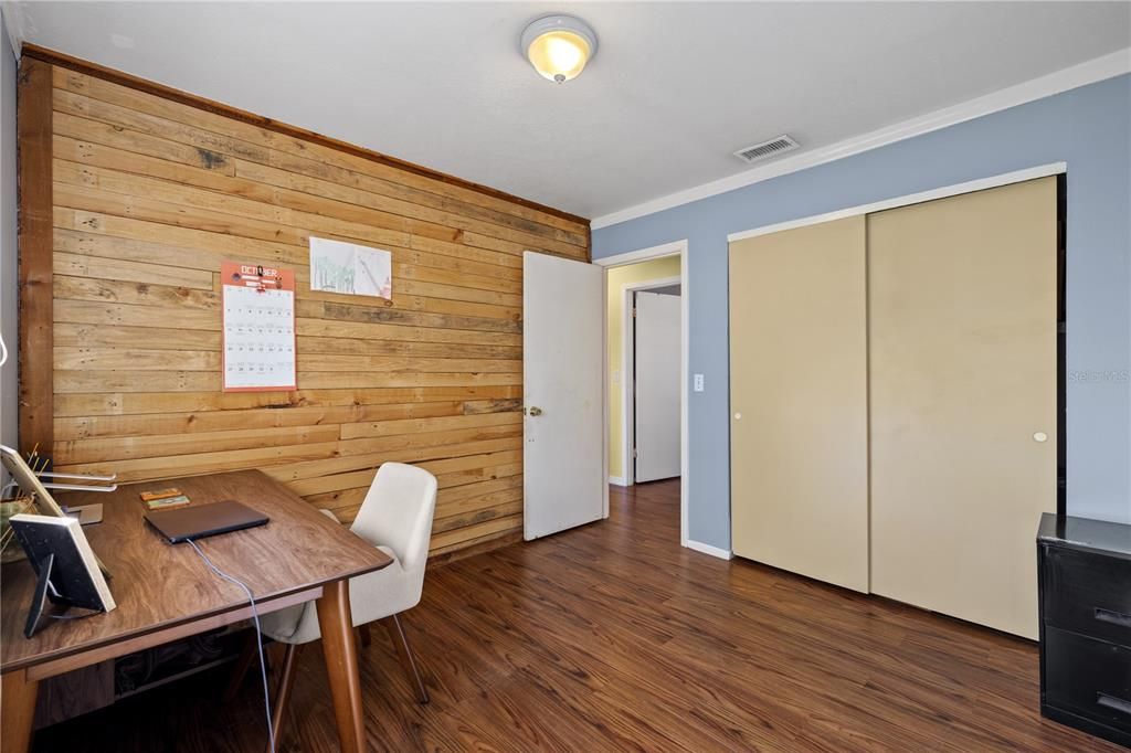 Bedroom 1 featuring a wood accent wall.