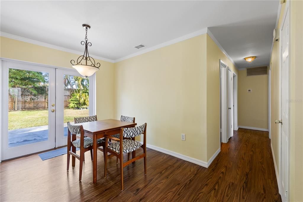 Dinning area featuring French doors that open to the backyard.