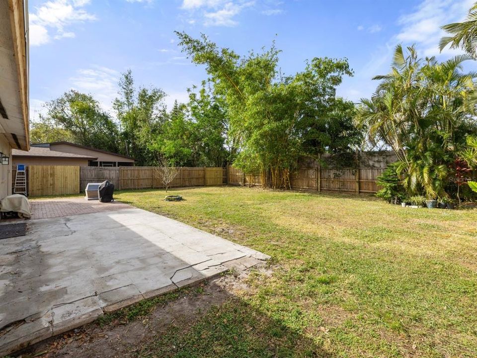 GINORMOUS fully fenced backyard. Trim on the back of the home is being freshly painted.