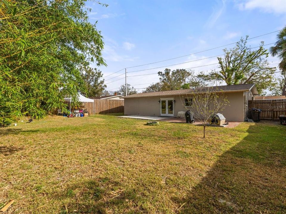 GINORMOUS fully fenced backyard. Trim on the back of the home is being freshly painted.