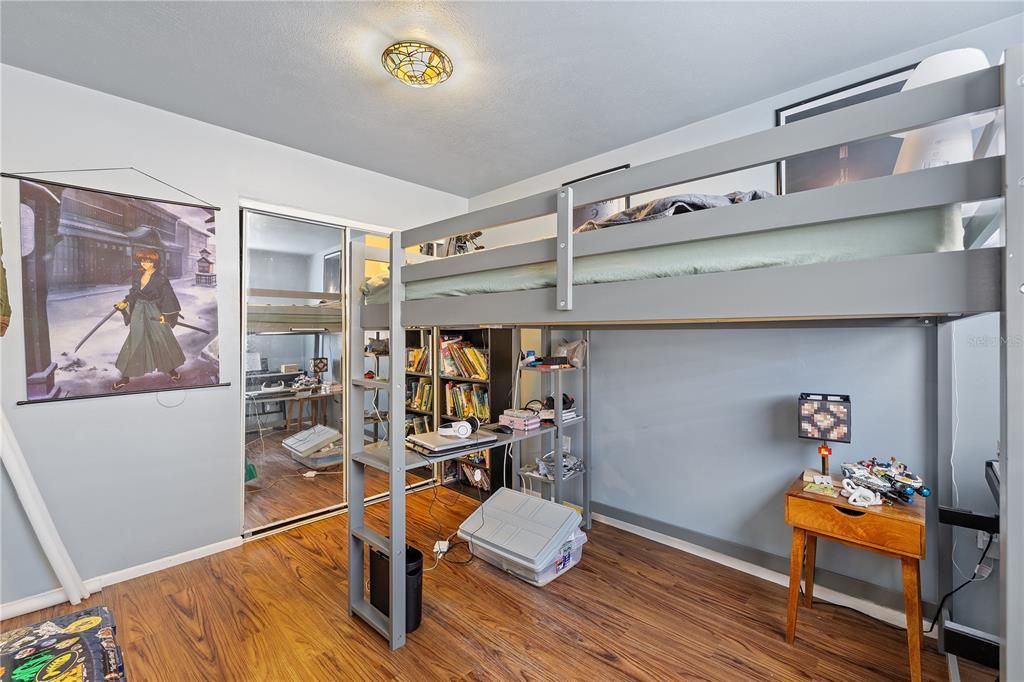 Bedroom 3 featuring laminate flooring.