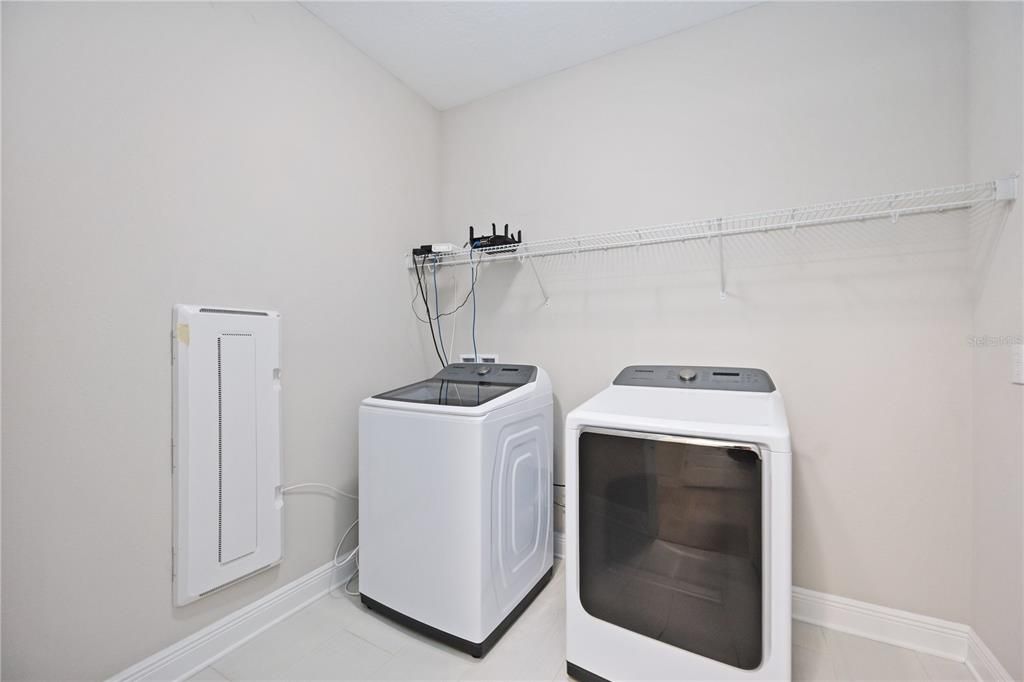 Laundry room with a shelf