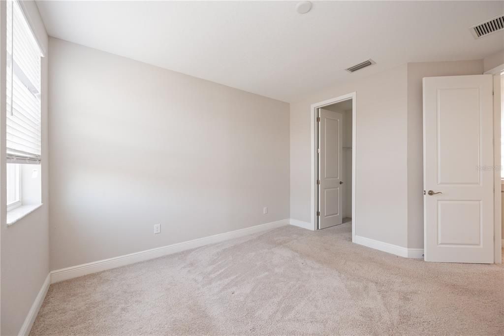 Guest bedroom with carpet flooring