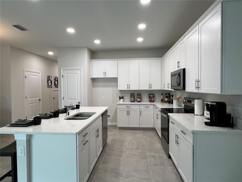 Kitchen with Big Island and Lots of Cabinet Space (photo of furnished model home)