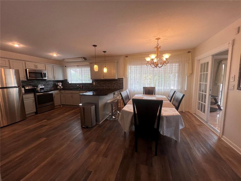 Kitchen with breakfast bar and Dining room that sits 6