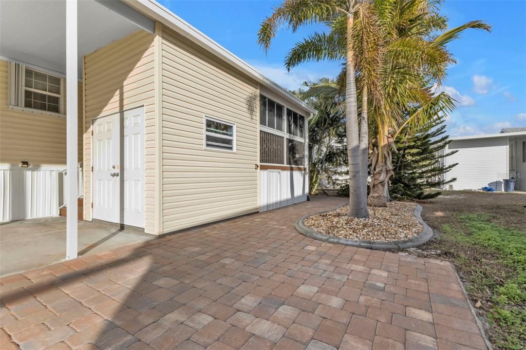 Extended driveway with pavers shows back lanai