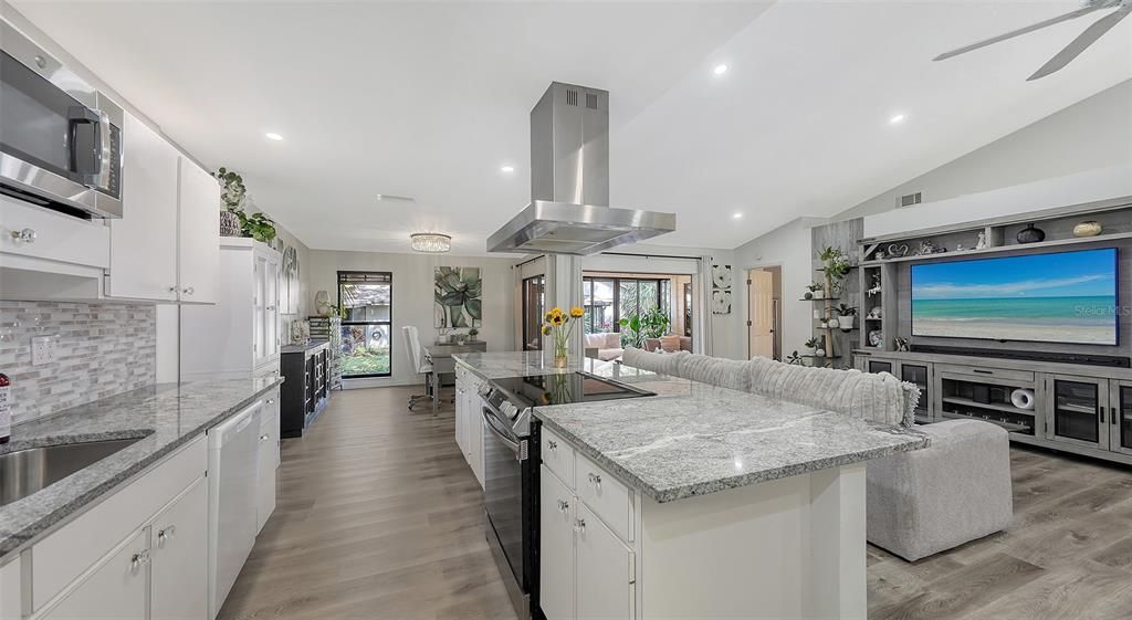 Kitchen overlooks Great Room with vaulted ceiling