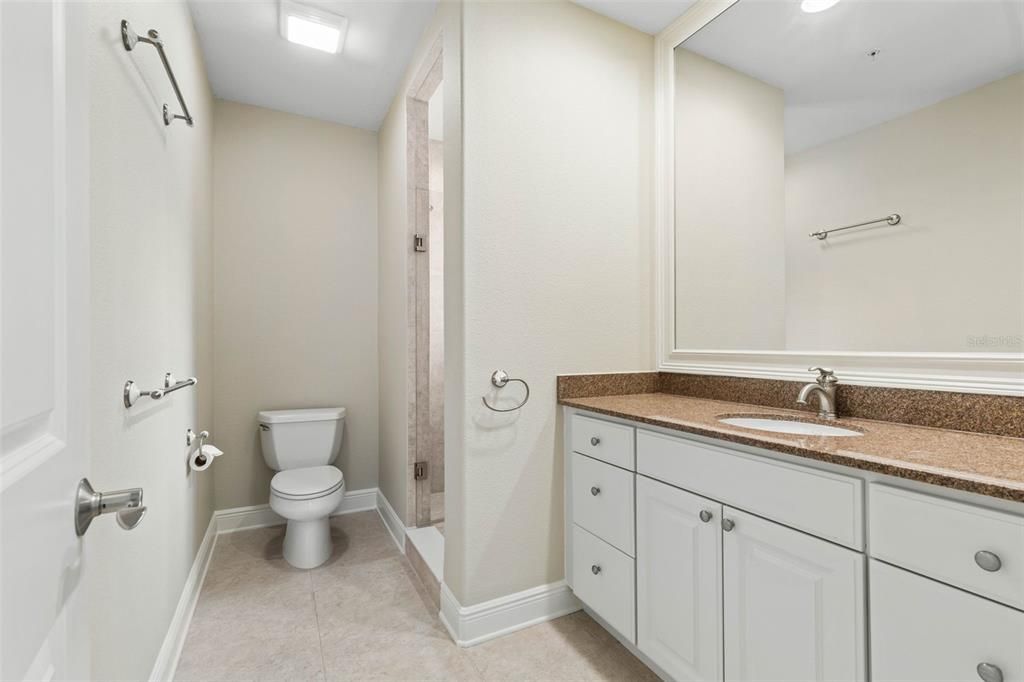 Large granite topped vanity in bathroom 3