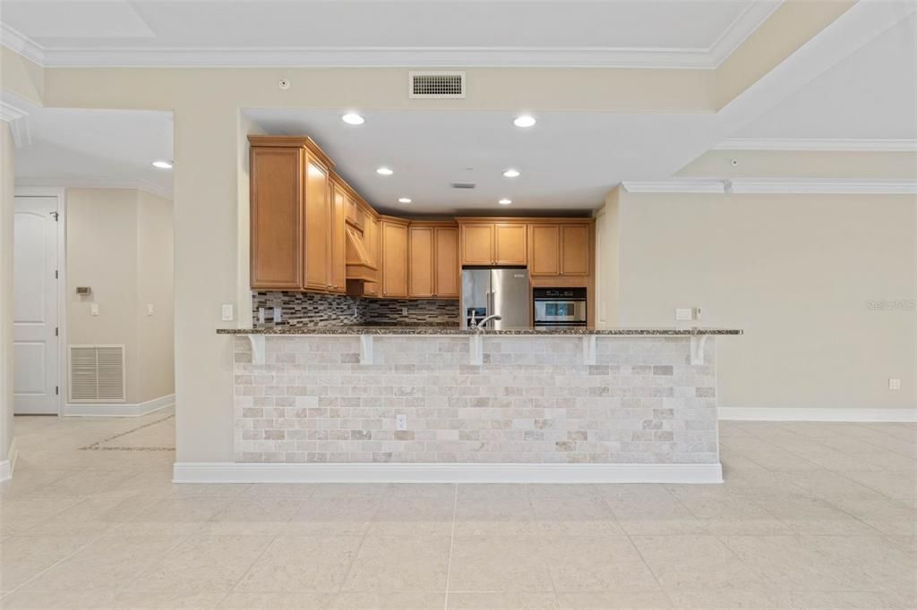 Breakfast bar has stone tile & granite top