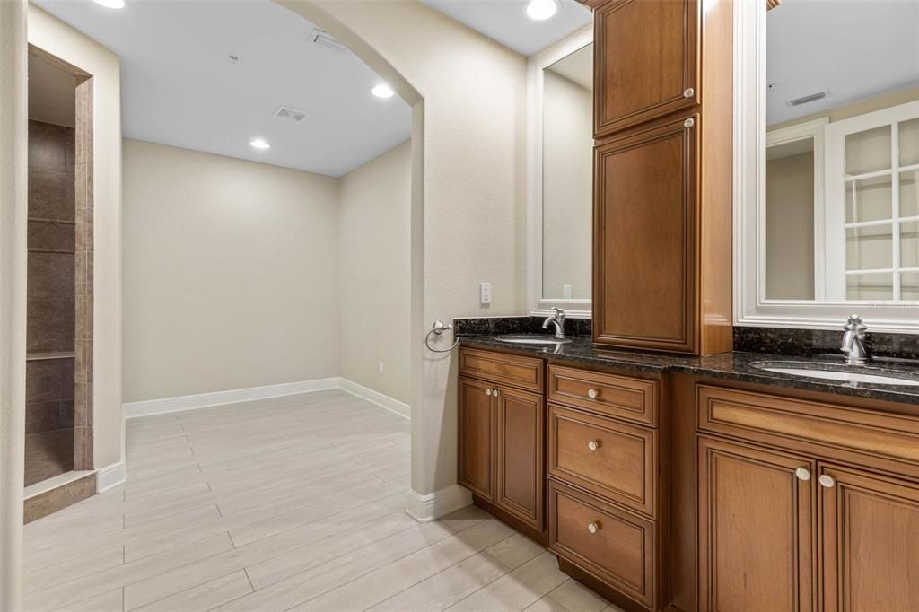 Primary ensuite bath has double vanities with granite tops