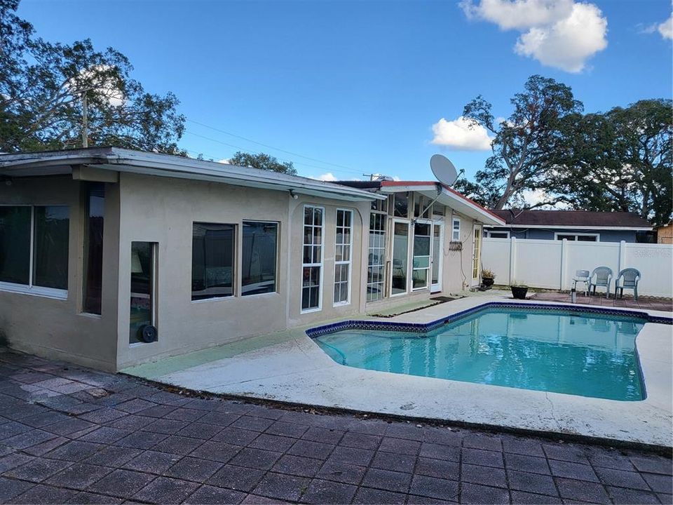 VIEW OF POOL AND LANAI FROM BACK YARDS