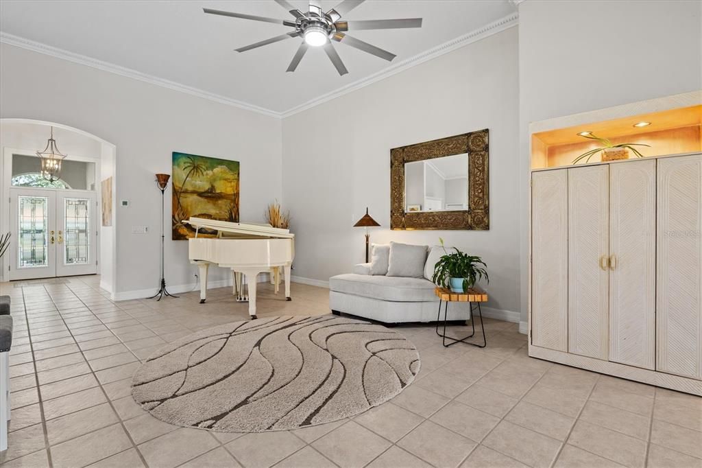 View towards the front of the home, as the gorgeous piano is showcased in what could be a formal living area.