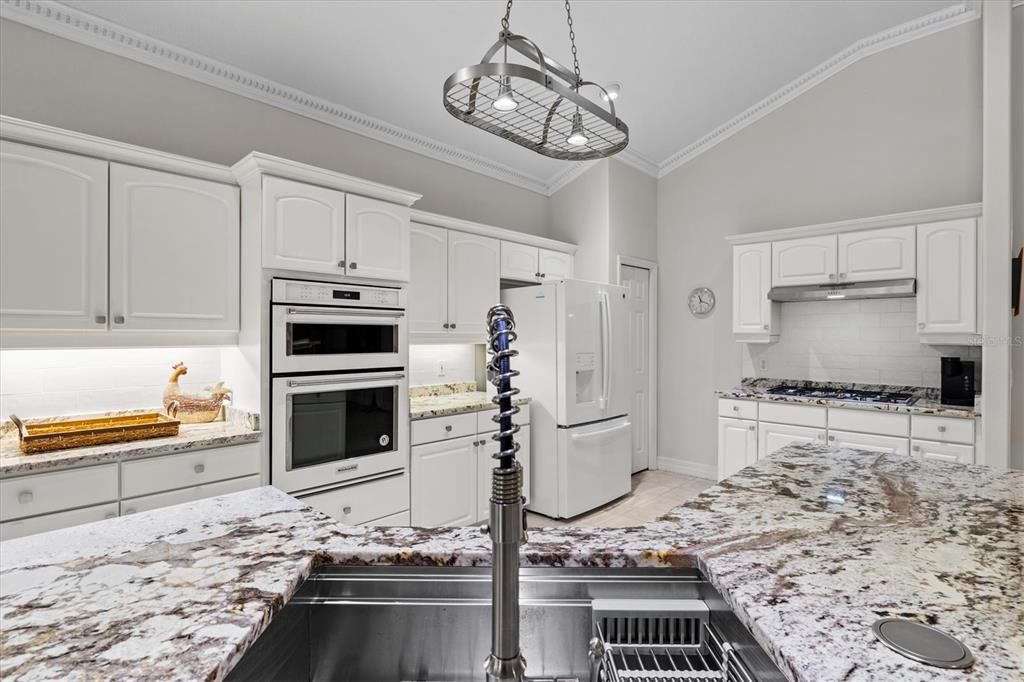 A closer look at the gorgeous granite counters. You will also notice a closet pantry tucked in the corner for additional storage.