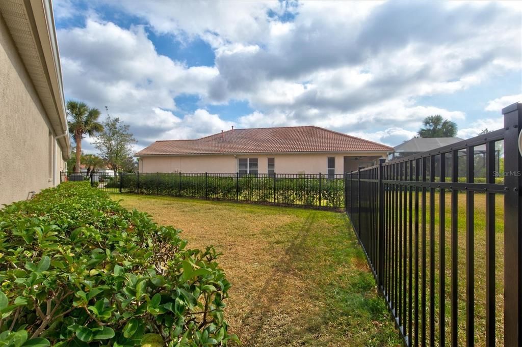 An aluminum fence secures the pups in their dog run, as they enjoy their own piece paradise outdoors.