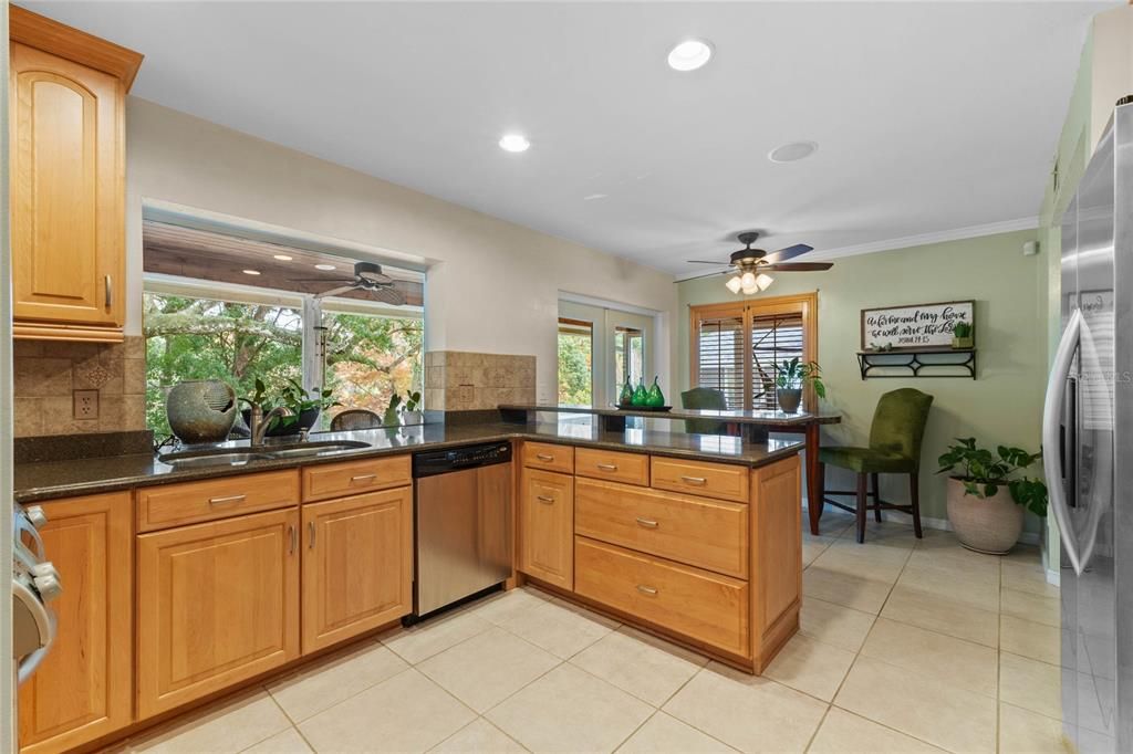 Plenty of cabinet space. Kitchen overlooks the stunning backyard and features a dinette.