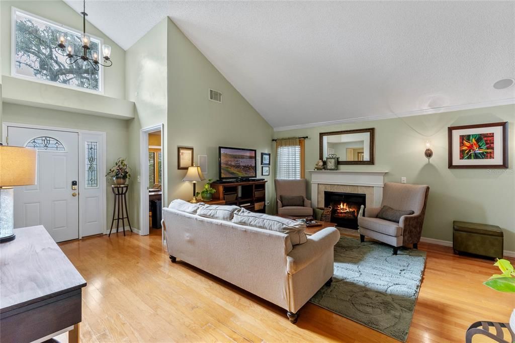 Entry way and living room with a wood burning fireplace