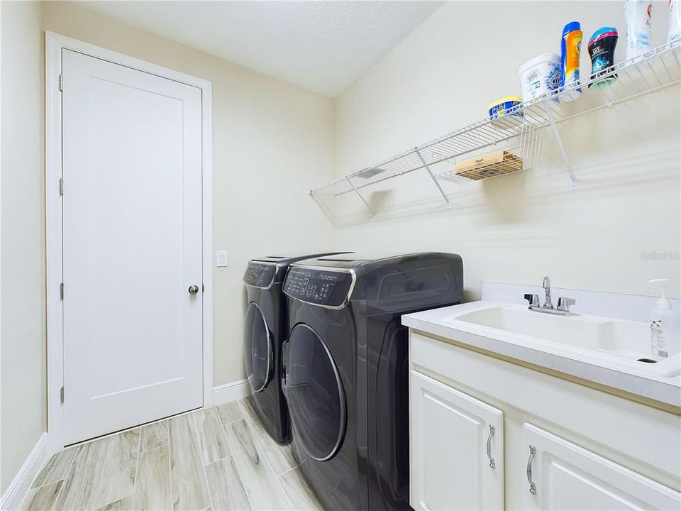 Upstairs laundry room and sink.