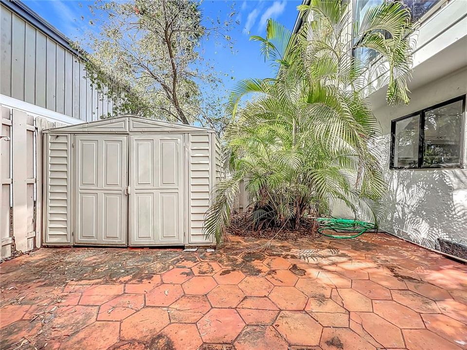 rear patio (shed does convey, outdoor shower also shown)