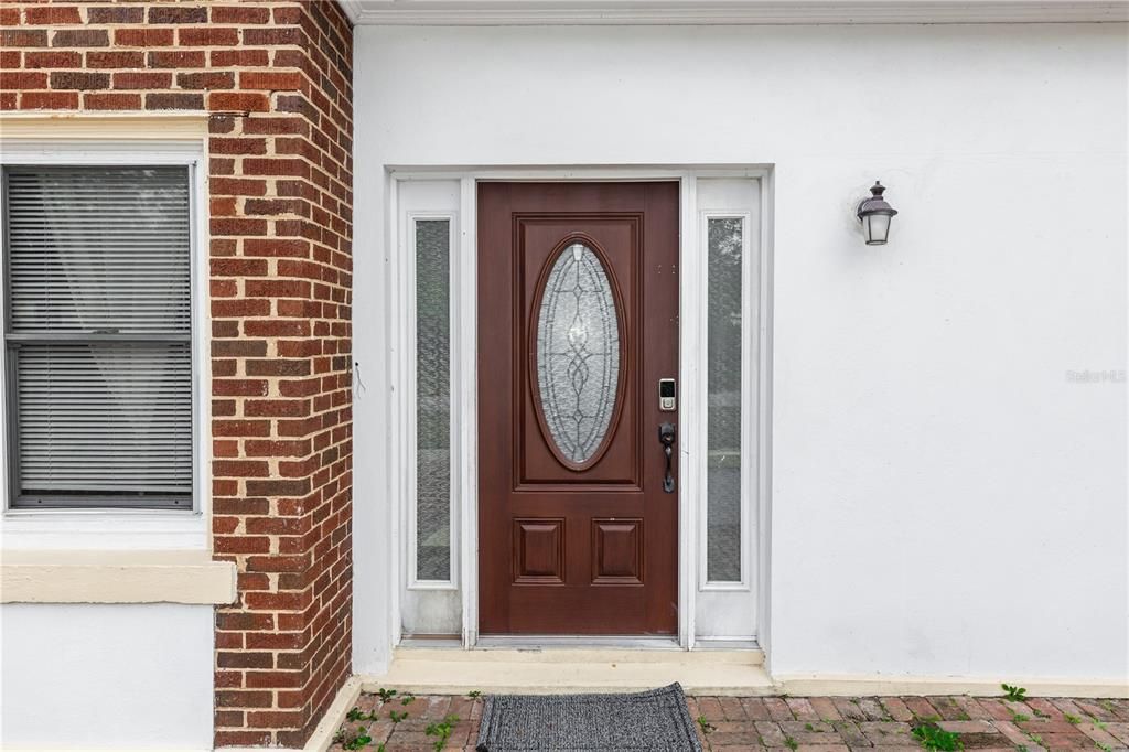 Entrance with Partial View of the Front Courtyard Covered with Bricks