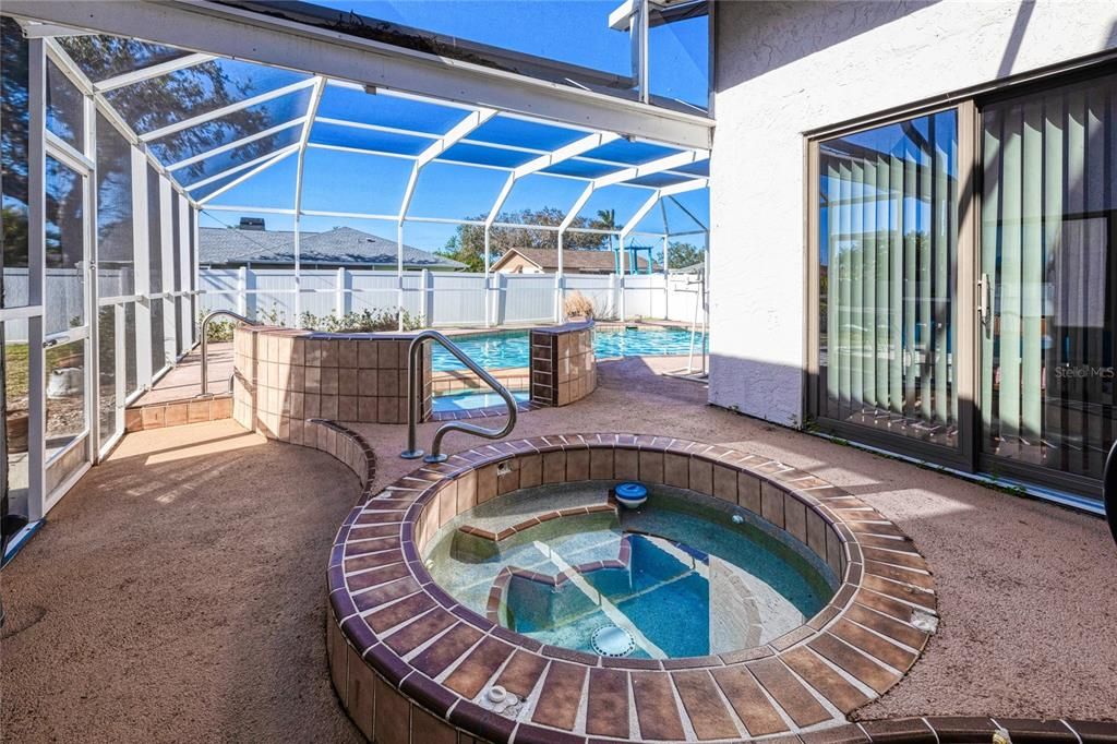 Large screened pool lanai with spa view