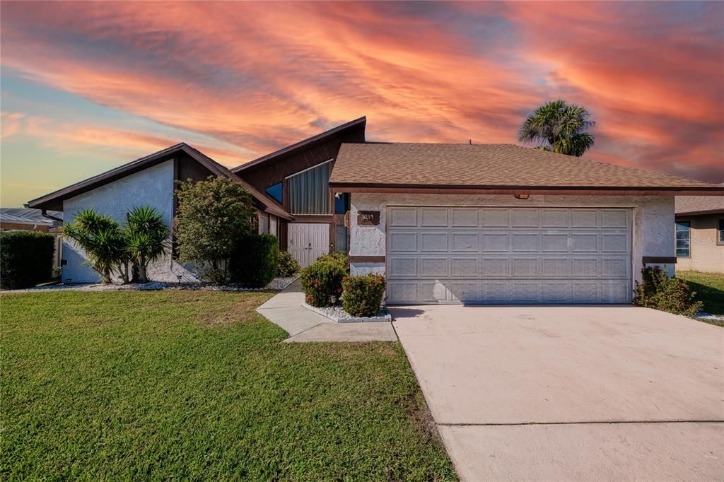 Stunning front view of home with sunset