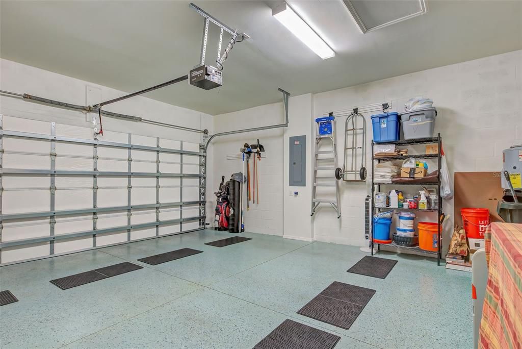 Clean garage with epoxy floor & insulated garage door.